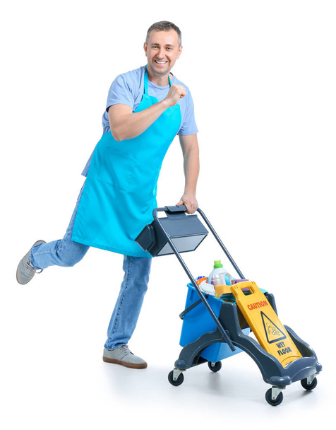 Mature worker of cleaning service with trolley and supplies on white background - Photo, image