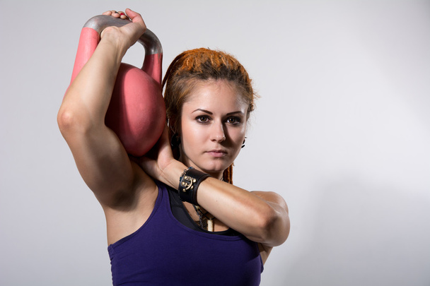 Portrait close up of young attractive female doing kettle bell e - Фото, зображення