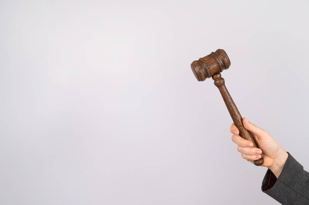 Woman holding judges gavel on white background.  - Foto, immagini