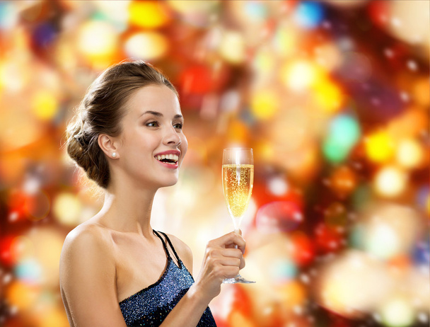 smiling woman holding glass of sparkling wine - Zdjęcie, obraz
