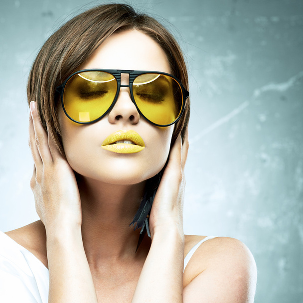 Woman portrait with yellow sun glasses. - Photo, Image