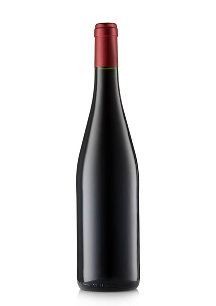 Bottle of red wine with red top on white. - Photo, Image