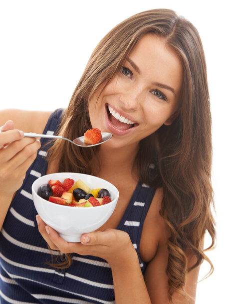 Healthy diet. A pretty young woman enjoying a bowl of fruit salad. - Photo, Image