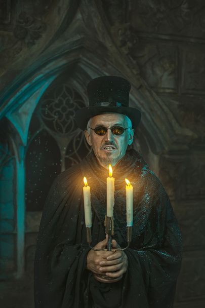 Warlock male with a candelabra in hand. - Photo, Image