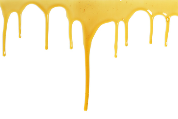 Honey flows over a white background - Foto, imagen