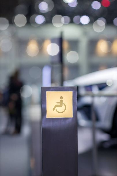 Lighting sign Disabled way.  Lighting signboard of handicap people way during the light is glowing. Wheelchair symbol on sign disabled sign for support wheelchair disabled people. - Photo, image