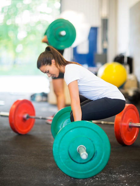 Fit Woman Picking Barbell At Healthclub - Foto, imagen