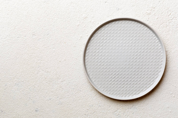 Top view of empty light plate on cement background. Empty space for your design. - Foto, immagini