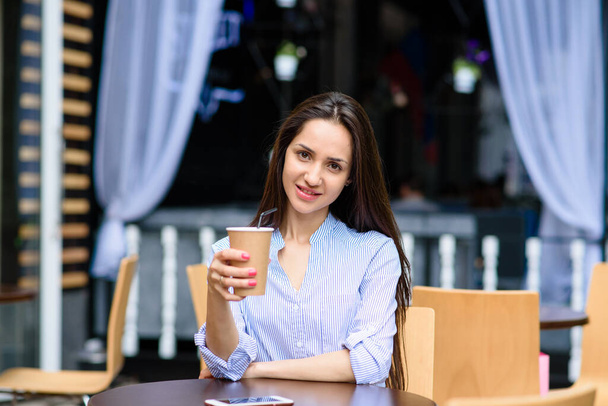 Beautiful young girl toasting outdoors on Open kitchen street food festival in Ljubljana, Slovenia. Popular summer urban tourist event in capital. - Фото, изображение