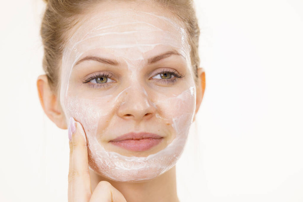 Young woman with cream cosmetic, mask moisture on her face. Beauty treatment. Skincare. - Фото, зображення