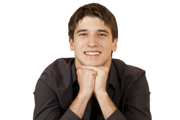 Young man sits propped on her hands chin - Photo, Image
