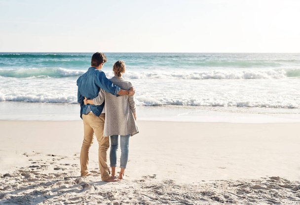 Getting lost in the beauty of nature. Shot of a middle aged couple spending the day at the beach. - Foto, Imagen
