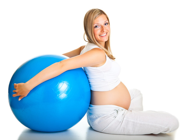 Pregnant woman excercises with gymnastic ball - Фото, изображение