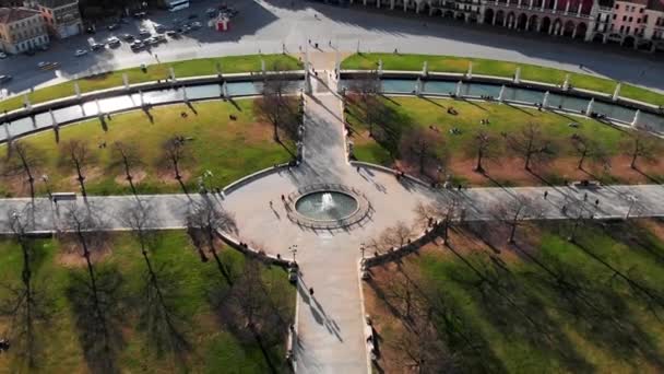 Aerial view of Padua in northern Italy. Drone view of Prato della Valle. A canal in the shape of an ellipse around the central part of the square. Bridges over the canal and a double row of statues - Footage, Video
