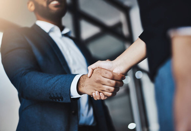 Lets join forces to become the best. Closeup shot of two unrecognizable businesspeople shaking hands in an office. - Foto, afbeelding