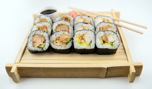 Teriyaki and fried chicken sushi rolls on Japanese bamboo mat wi - Photo, Image