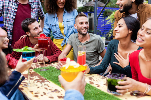 Grupo de amigos disfrutando de bebidas de moda por la tarde en el bar de la terraza happy hours - Foto, imagen