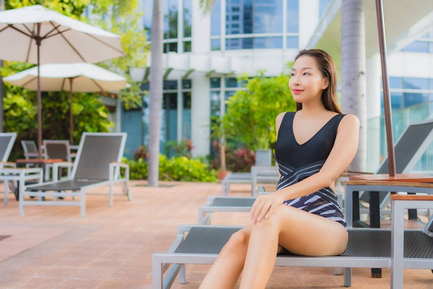 Portrait beautiful young asian woman leisure relax smile around outdoor swimming pool for vacation - Photo, Image