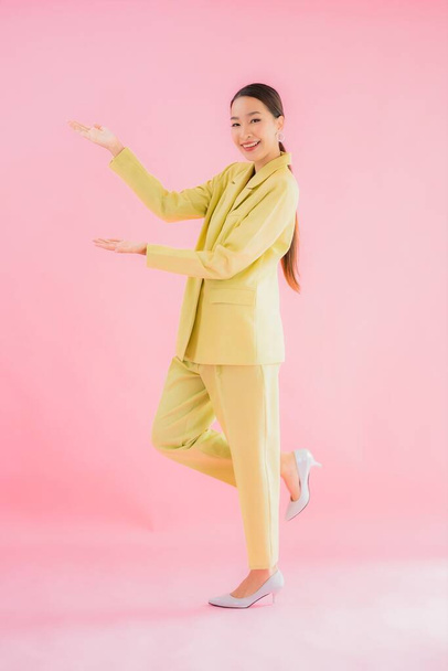 Portrait beautiful young asian business woman smile in action on pink color background - Photo, Image
