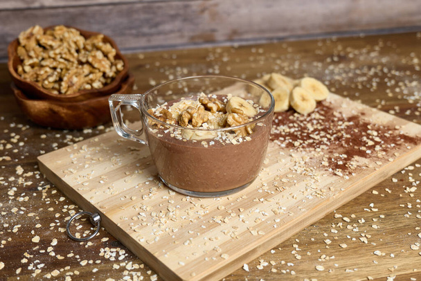 Healthy smoothie with banana and cacao in brown background - Photo, Image