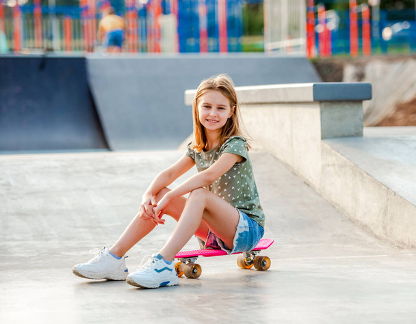 Girl with skateboard outdoors - Photo, Image