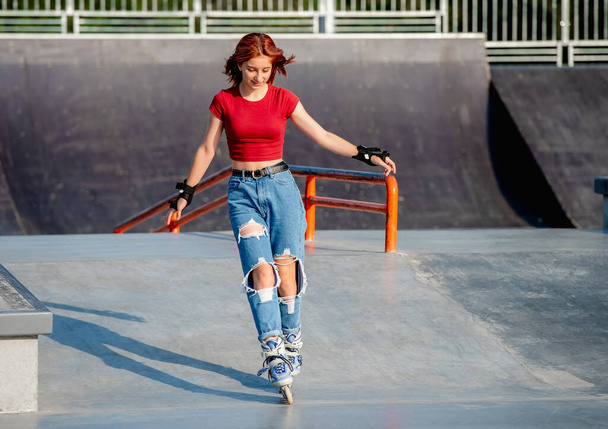 Girl with roller skates outdoors - Fotó, kép