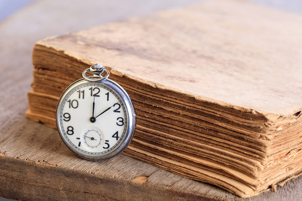 Pocket watch next to book - Photo, Image