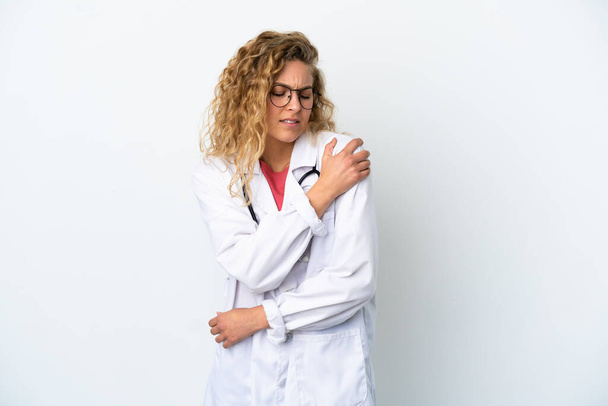Young doctor blonde woman isolated on white background suffering from pain in shoulder for having made an effort - Photo, Image
