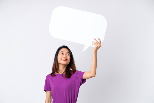 Young Vietnamese woman isolated on white background holding an empty speech bubble - Photo, Image