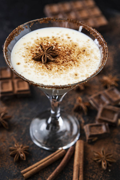 Homemade eggnog with cinnamon on dark table. Traditional Christmas dessert - Photo, image