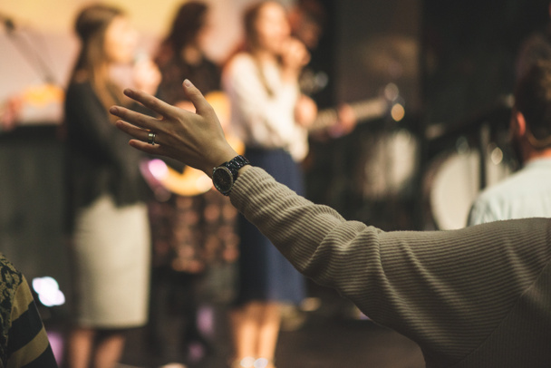 Руки в повітря жінки, яка хвалить Бога в церковному служінні. - Фото, зображення