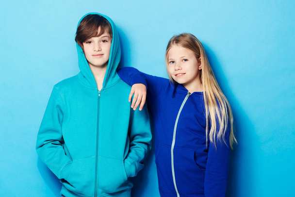 Cool kids. Portrait of a young boy and a young girl in the studio. - Fotografie, Obrázek