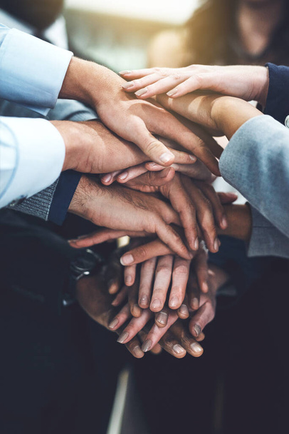 We work best when we collaborate together. Closeup shot of a group of businesspeople joining their hands together in unity. - Foto, Bild