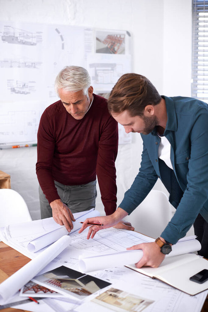 Putting the final touches on the plans. Cropped shot of two male architects working together in their office. - Photo, Image