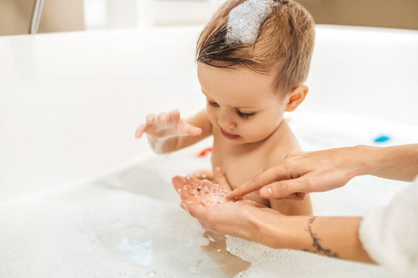 Cute male child sitting in the bathtub - 写真・画像