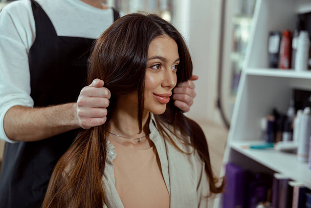 Portrait of salon female customer looking happy while doing hairstyle - Valokuva, kuva
