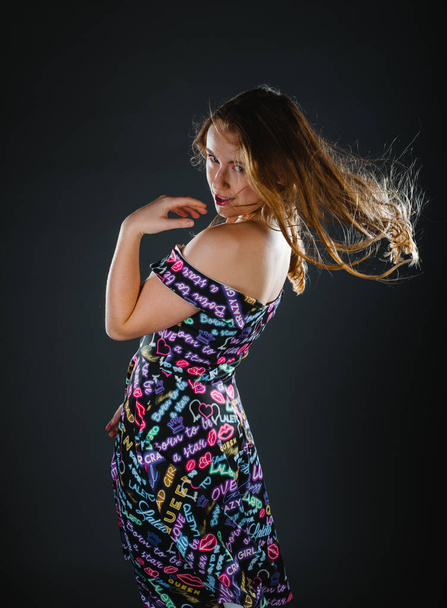 Studio body shot of a fashion female model posing in modern clothing - Foto, afbeelding