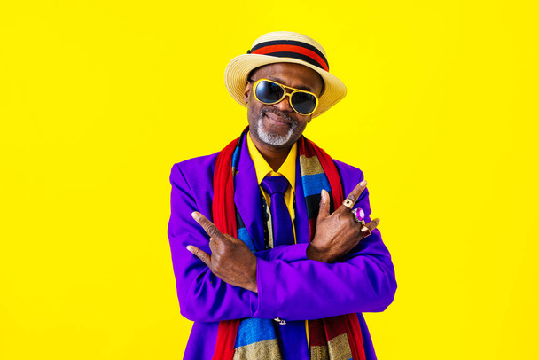 Cool senior man with fashionable clothing style portrait on colored background - Funny old male pensioner with eccentric style having fun - Photo, image