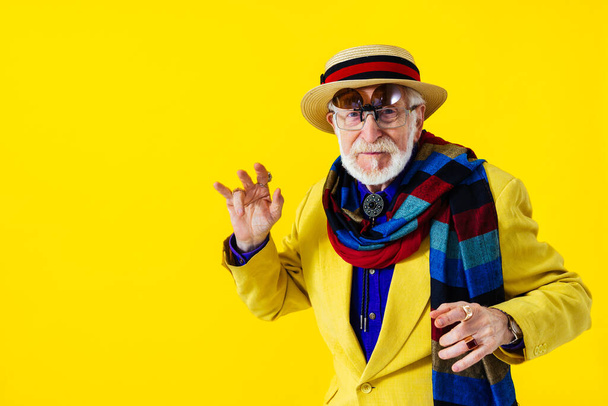 Cool senior man with fashionable clothing style portrait on colored background - Funny old male pensioner with eccentric style having fun - Foto, imagen