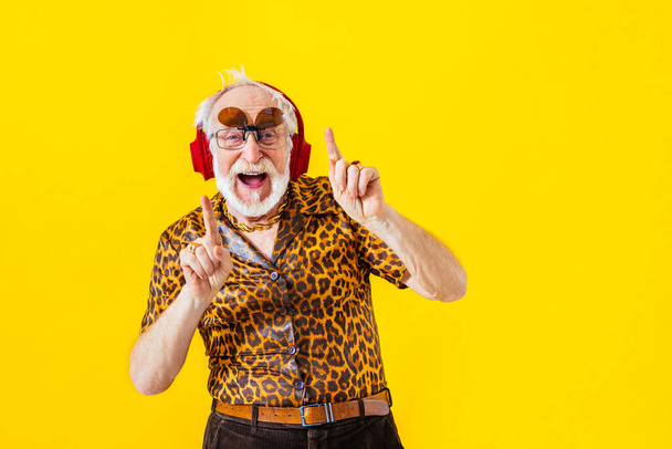 Cool senior man with fashionable clothing style portrait on colored background - Funny old male pensioner with eccentric style having fun - Фото, зображення