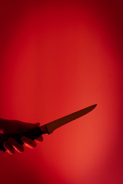 silhouette of a knife on a red background - Фото, зображення