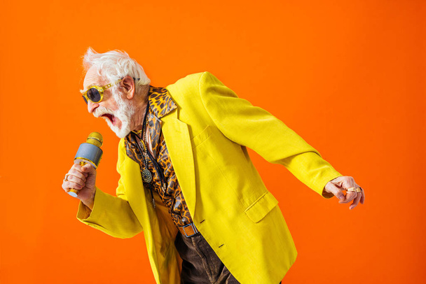 Cool senior man with fashionable clothing style portrait on colored background - Funny old male pensioner with eccentric style having fun - Фото, изображение
