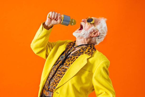 Cool senior man with fashionable clothing style portrait on colored background - Funny old male pensioner with eccentric style having fun - Zdjęcie, obraz