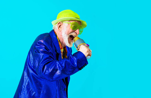 Cool senior man with fashionable clothing style portrait on colored background - Funny old male pensioner with eccentric style having fun - Fotó, kép