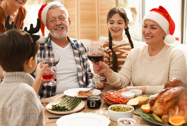 Happy family enjoying festive dinner at home. Christmas celebration - Zdjęcie, obraz