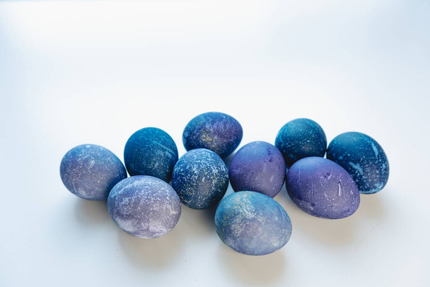 Space colored eggs on white background. Easter holiday - Фото, изображение