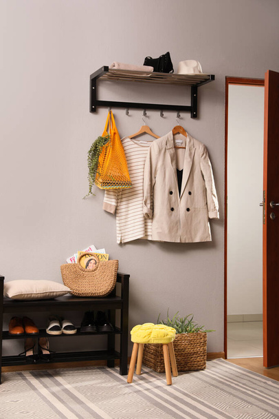 Hallway interior with stylish furniture, clothes and accessories - Фото, изображение