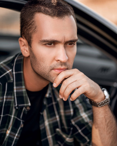 handsome manly man with short bristles in a checkered shirt - Photo, Image