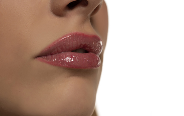 Beautiful puffy feminine lips with nude lipstick on white background - Photo, Image