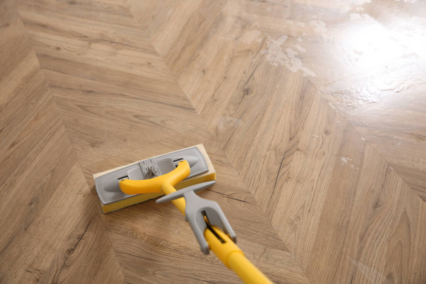 Washing of parquet floor with mop, above view. Space for text - Фото, изображение